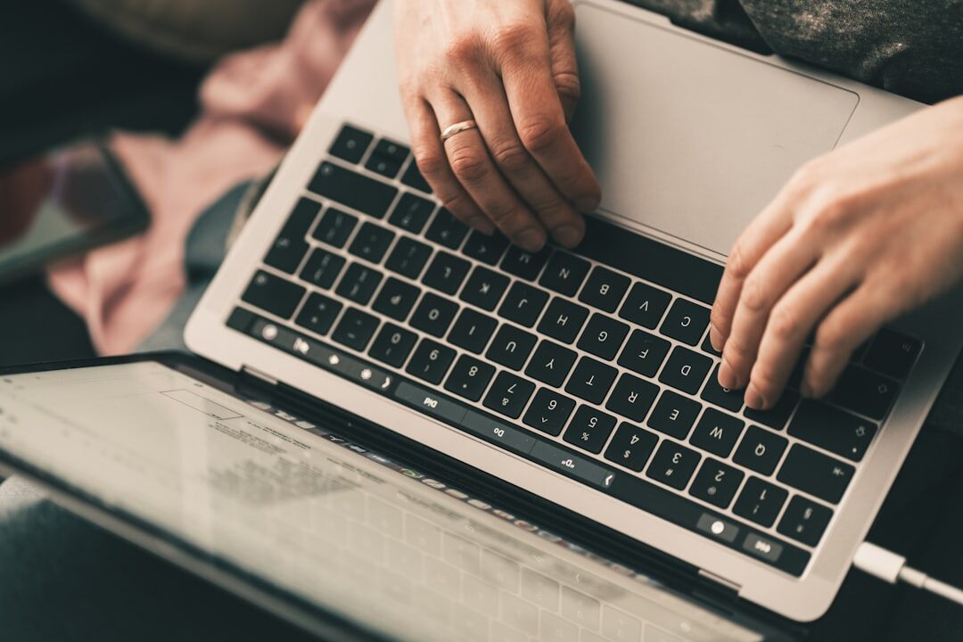 writer typing on laptop